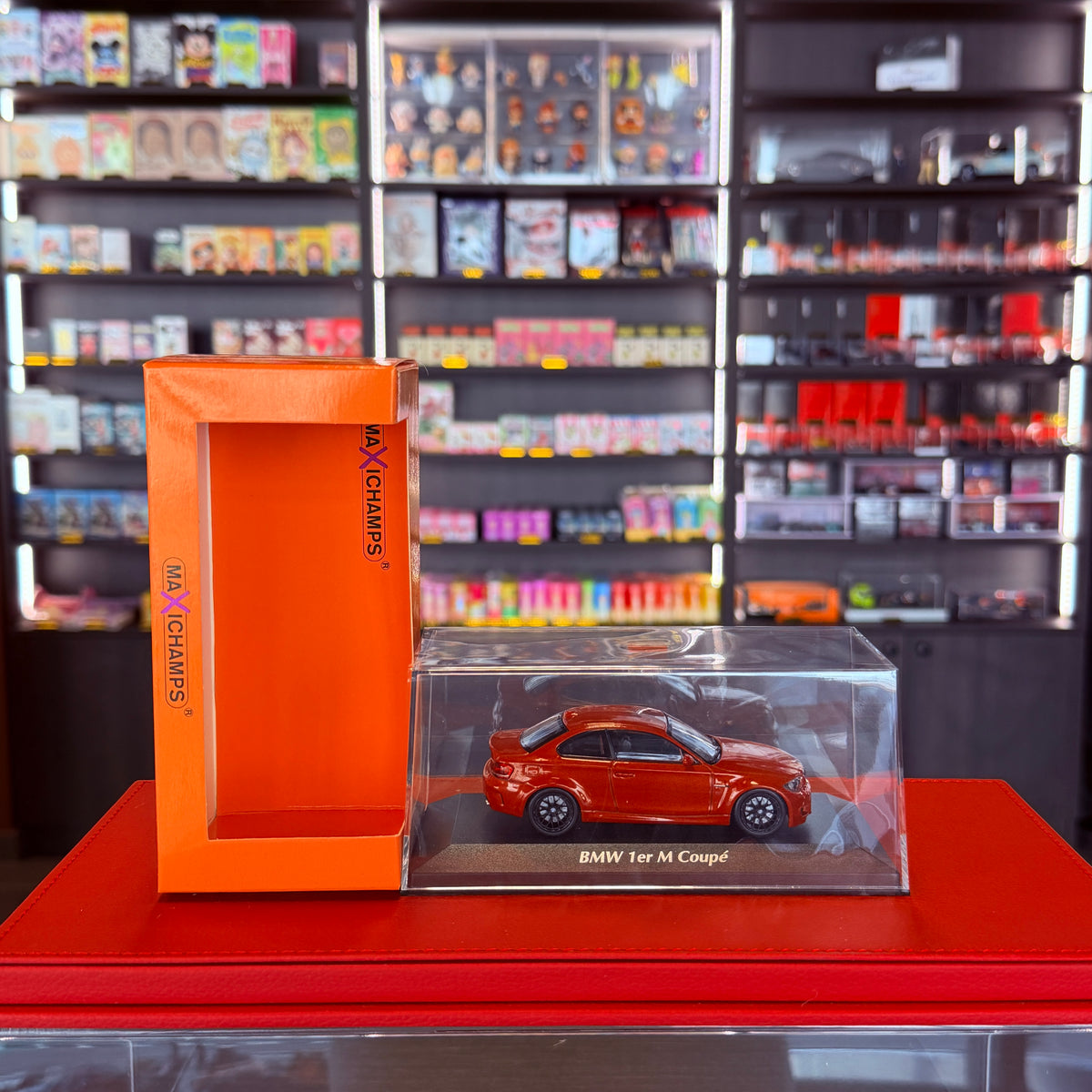 BMW 1. řady M Coupé (E82) 2011 oranžová metalíza 1:43 od Maxichamps